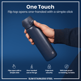 A dark-blue, slim stainless steel water bottle is held; its flip top opens one-handed via a simple click. The bottle is shown against a dark-blue background. 