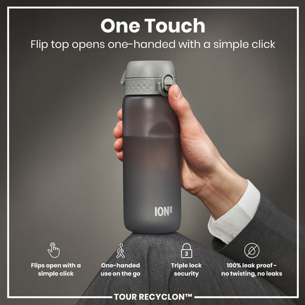 A dark-grey water bottle with a flip top is held; its lid is opened one-handed by a simple click. The bottle features a triple lock security and is leak-proof. The background is neutral. TOUR RECYCLON™