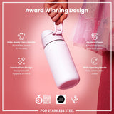 A pink stainless steel water bottle is being held; it features a hide-away handle, hygiene cover, and wide mouth. The bottle is an award-winning design.
