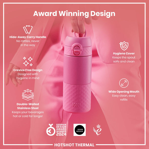 A pink, double-walled stainless steel water bottle is being held; it features a hide-away handle, crevice-free design, hygiene cover, and wide opening mouth. The bottle is award-winning.