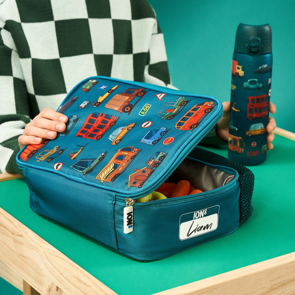 A rectangular teal lunchbox showcases colorful cartoon vehicles including cars, buses, and trucks with road signs such as "Stop" and "A68" in a playful pattern.
