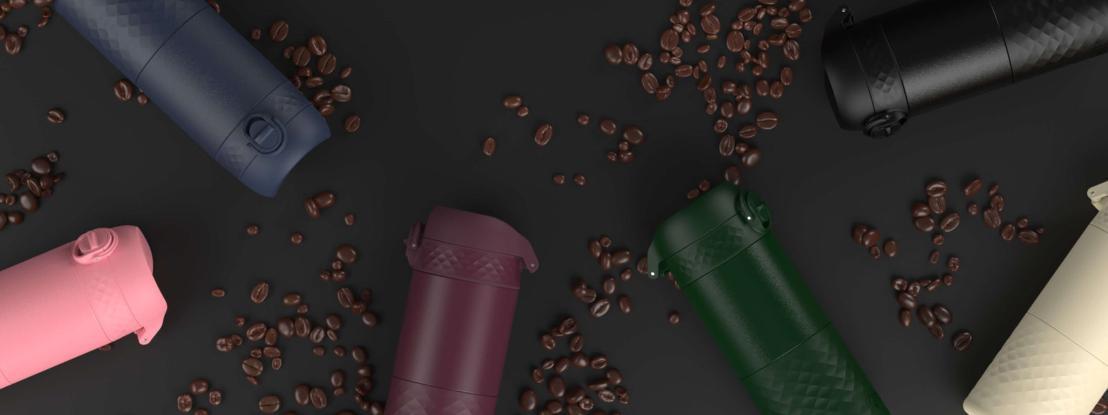 Several portable coffee makers, in various colors, are scattered on a dark surface amongst coffee beans.