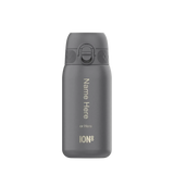 A gray water bottle stands upright with a flip-top lid against a plain background. Text reads: 